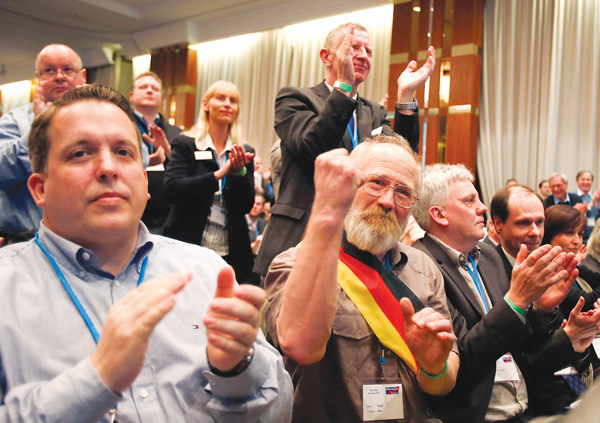 Members of the new anti-Euro party Alternative for Germany react during the party’s founding convention in Berlin, Germany, on Sunday. The organizers had to open a second room to squeeze in more than 1,500 members who had come from across the country to adopt a program and vote for a party board.