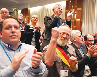 Members of the new anti-Euro party Alternative for Germany react during the party’s founding convention in Berlin, Germany, on Sunday. The organizers had to open a second room to squeeze in more than 1,500 members who had come from across the country to adopt a program and vote for a party board.