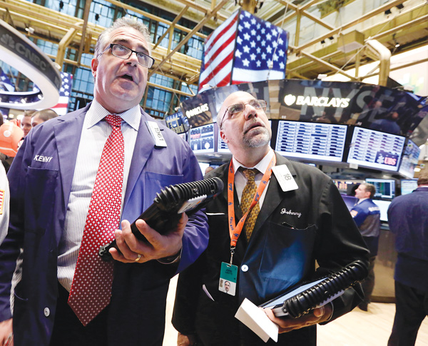 Traders Kenneth Polcari, left, and John Liotti work on the floor of the New York Stock Exchange. They were at work Friday.