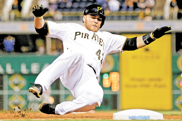 Pittsburgh Pirates’ Russell Martin slides into third base during a game against the St. Louis Cardinals in Pittsburgh on Monday.