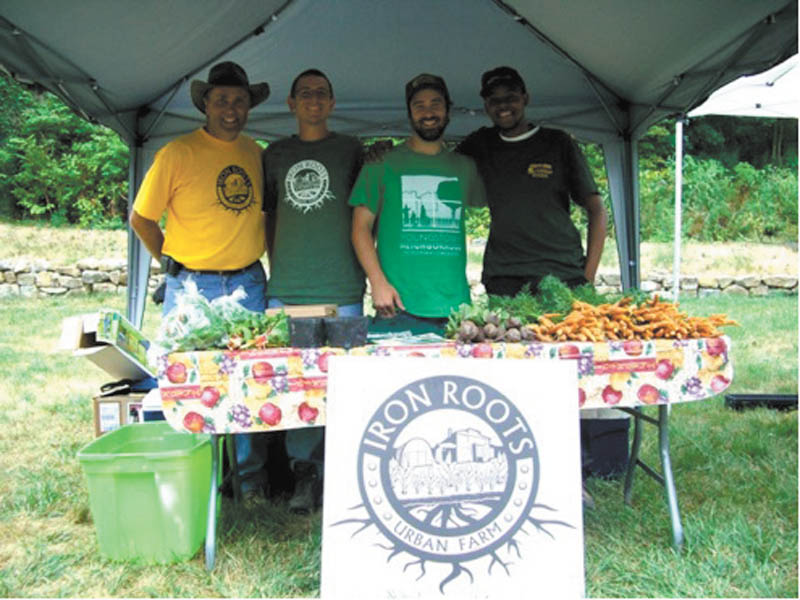 SPECIAL TO THE VINDICATOR
The second annual Poland Village Farmers Market will begin June 14 on the lawn of Poland Village Town Hall. Iron Roots Urban Farm, one of the vendors, will provide produce for the market. Proudly showing a display of their produce are Curtis Moore, left, director of Iron Roots; and employees Rick Price, Matthew Porter and Demetrius Pugh.