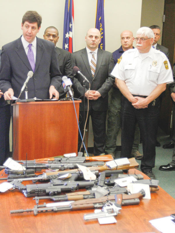U.S. Attorney Steven M. Dettelbach reveals the results of an investigation and explains why close to 200 agents fanned out across Warren and arrested 65 people. Officials said they put a major dent in a Detroit-to-Warren drug-and guns operation. At right is Warren Police Chief Tim Bowers.