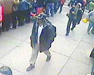 This image released by the FBI on Thursday shows what the agency is calling suspect No. 1, front, in black cap, and suspect No. 2, in white cap, back right, walking in Boston before the explosions at Monday’s marathon.