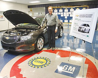 Gary Altman, chief engineer of Chevrolet’s 2014 Cruze Clean Turbo Diesel, stands with one of the models at GM Lordstown on Thursday. The model will begin arriving at major metropolitan dealerships in May and others across the country and in Canada by this fall.