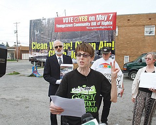 Supporters of an anti-fracking charter amendment on Youngstown’s May 7 ballot unveil billboards. Lynn Anderson, front, spoke Thursday in support of the amendment. Behind her, from left, are Tom Cvetkovich, Jack Slanina and Susie Beiersdorfer. This billboard is on South Avenue.