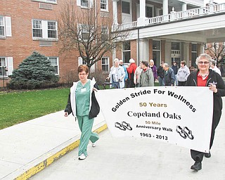 William D. Lewis | The Vindicator
To celebrate Copeland Oaks Retirement Community’s 50th anniversary, the wellness director at the facility, Susan Bleggi, came up with Golden Stride, a 50-mile walk — one mile at a time — as something that combines fitness and fun for residents and staff members. Carrying the banner are employees Linda Fox, left, and Liz Phillips.