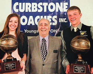 High school basketball standouts Kaye Solak of Lowelville and Chad Oliver of Bristol flank the Curbstone Coaches Association’s Sam Rogers after receiving their student athlete of the year awards during the organization’s annual basketball recognition banquet Sunday at The Georgetown in Boardman.