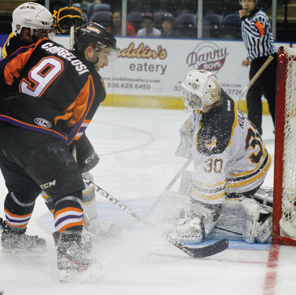 Austin Cangelosi (9) of the Youngstown Phantoms make an attempt on the goal which is defended by Green Bay goalie Tony Kujava (30) and defensman Jake Linhart (88) during Game 4 of their first-round USHL Clark Cup playoff series Sunday at the Covelli Centre in Youngstown. The Phantoms, who led the series 2-1 going into Sunday’s contest, ousted the defending league champion Gamblers, 3-1, with Cam Brown netting the game-winning goal with 5:52 remaining in the third period and teammate Alexander Dahl adding an empty-net goal for insurance.