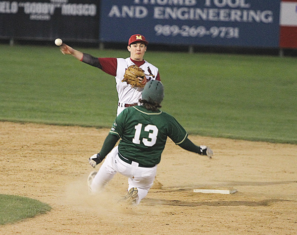 Ursuline’s Vinnie Boerio (13) tries to break up a double play as Cardinal Mooney’s Gino DiVincenzo fires to first base during a game at Cene Park on Monday night. Ursuline won, 7-2.