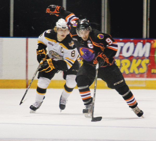 Phantoms forward Austin Cangelosi (9) skates away from Green Bay’s Sheldon Dries (8) during Sunday’s game
at the Covelli Centre.