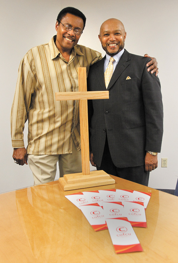 The Rev. Henry L. McNeil, left, serves as president of the Economic Empowerment Steering Committee of the
Community of Faith Credit Union with the Rev. Kenneth Simon as vice president. Brochures about the COFCU are
on the table. This week, a letter campaign begins to raise funds.