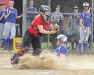 Poland’s Taylor Miokovic is out at the plate on a force play as Canfield catcher Amelia Manenti takes the throw during a game Tuesday. Canfield won, 4-3, on Kayley Keller’s walk-off home run in the seventh inning.