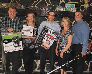 DUSTIN LIVESAY | THE VINDICATOR
Officials of the Strimbu Memorial Fund, from left to right, Dennis Lieb of Sharon, Pa., treasurer; Connie Schenker of Sharpsville, Pa., assistant to the board; Jim Grasso of Sharon, vice president; Nancy Lukasko of Brookfield, board member; and Bernie Carpenter of Brookfield, board member, hold items that will be auctioned at the 24th annual Strimbu Memorial Barbecue on May 8 in Brookfield.