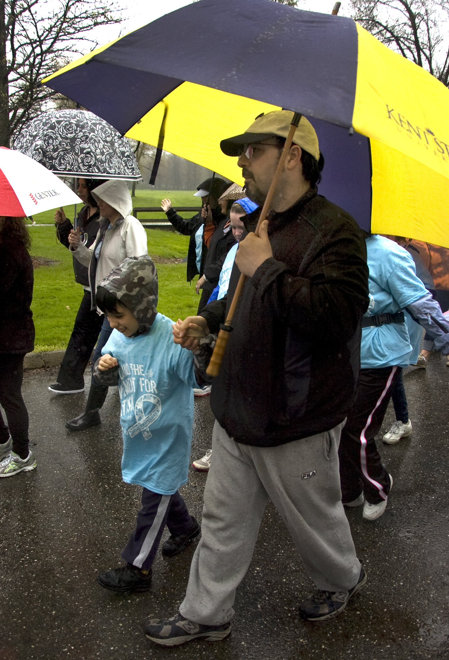 Kelli Cardinal/The Vindicator
Mauro Divieste, of Howland, walks Sunday with his son Michael 10, during the Pound the Pavement for Autism in Howland Township Park.  