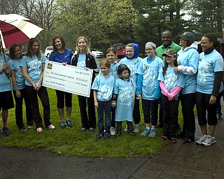 Kelli Cardinal/The Vindicator
Leah Wilson (center, left) of the Rich Center for Autism, and Liz Follet, of Covelli Enterprizes, hold the $12,000 check Sunday during a presentation before the Pound the Pavement for Autism walk in Howland Township Park.