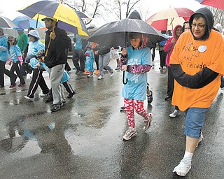 Pam Wells, right, of Kinsman walks with her granddaughter, MacKenzie Collins, 8, during the “Pound the Pavement for Autism” walk Sunday in Howland Township Park. Wells was walking for her grandson, J.J. Juhasz, 7, a student at the Rich Center for Autism.
