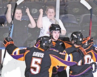 Phantoms defenseman Eric Sweetman, center, celebrates with teammates Tommy Davis and Josh Nenadal after scoring a first-period goal in Tuesday’s playoff win over Dubuque at the Covelli Centre.