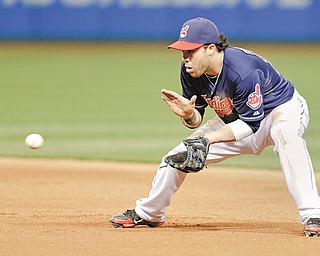 Cleveland Indians’ Jason Kipnis fields a ball hit by Philadelphia Phillies’ Ben Revere during the seventh inning of a baseball game, Tuesday in Cleveland. Revere grounded into a double play.
