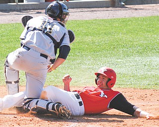 Youngstown State’s Nick DiNello is tagged out at home by Kent State catcher Tommy Monnot during Wednesday’s game at Eastwood Field. The Golden Flashes edged the Penguins, 9-8.
