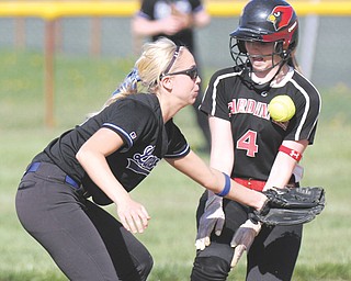 Canfield’s Sydney Opladen is safe after stealing second base as Lakeview’s Taylor Waid misses the throw during their game Thursday in Canfield. The Cardinals cruised to a 7-3 win over the Bulldogs behind senior Abby Baker,
who pitched a two-hitter and struck out four batters.
