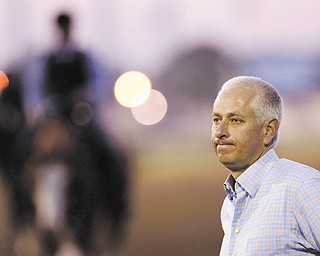 Trainer Todd Pletcher watches the morning workouts at Churchill Downs in Louisville, Ky. On Saturday, Pletcher has a plethora of contenders in the 139th Kentucky Derby, including Verrazano and Revolutionary.