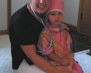 Natalie Zwingler of Calcutta works in the NICU at Akron Children's Hospital in St. Elizabeth Health Center in Youngstown. This photo was sent in by her sister-in-law, Alyson Zwingler of Columbiana, who writes that Natalie "is a very caring and compassionate nurse and aunt." In the photo, Natalie gives a nursing outfit to Alyson's daughter Payton, now 5, for Payton's 3rd birthday. Alyson says, "Payton wants to be just like Aunt Natalie when she grows up!"