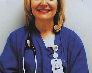 Pam Carroll of New Middletown, a nurse in the surgery department at St. Elizabeth Health Center, has received Employee of the Month and Employee of the Year at St. E's. Granddaughter Grace Burchfield, also of New Middletown, submitted this photo.
