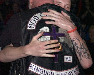 Kelli Cardinal/The Vindicator
Mitchell Mamula, of Gerard, hugs Rev. Mike Wimer, of God Chasers MC, after a demonstration Saturday where Mamula committed himself to the Lord during the Men's Rally in the Valley at the Covelli Center in Youngstown. Wimer is the Pennsylvania chapter president of the motorcycle club.