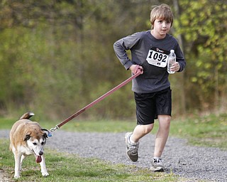MADELYN P. HASTINGS | THE VINDICATOR
Evan Milford, 11, of McDonald runs with his German Shepherd Beagle mix, Gabby during the 1st annual Tails on Trails 5K walk at Austintown Township Park. All proceeds benefit Friends of Fido Mahoning County Dog Pound.