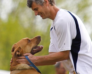 MADELYN P. HASTINGS | THE VINDICATOR
Stephen Flora of Youngstown embraces his rescued mix breed, Rufus at the 1st annual Tails on Trails 5K walk at Austintown Township Park. All proceeds benefit Friends of Fido Mahoning County Dog Pound.