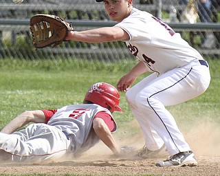 William D. Lewis\The Vindicator NilesTyler Weiry(8) gets back to first ahead of throw during a pickoff attempt. Making catch for Fitch is Phil socha(14).