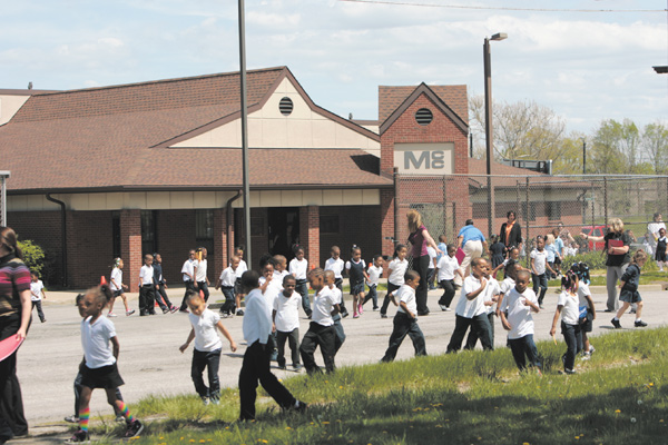 Children and their teachers gather outside the Mill Creek Children’s Center preschool on Essex Street on Youngstown’s South Side after evacuating the building Monday afternoon due to a bomb threat written on a girls’ restroom wall in the adjoining Youngstown Community School. Police searched the buildings and found no bomb, and the children and staff re-entered the buildings after 30 minutes outside.