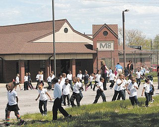 Children and their teachers gather outside the Mill Creek Children’s Center preschool on Essex Street on Youngstown’s South Side after evacuating the building Monday afternoon due to a bomb threat written on a girls’ restroom wall in the adjoining Youngstown Community School. Police searched the buildings and found no bomb, and the children and staff re-entered the buildings after 30 minutes outside.