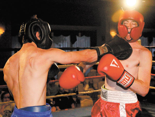 Ryan Patterson of Poland, left, hits Joshua Voland of Neshannock, Pa., on Monday night during the first round
of the K.O. Drugs Boxing Tournament at St. Lucy’s Palermo Center in Campbell.