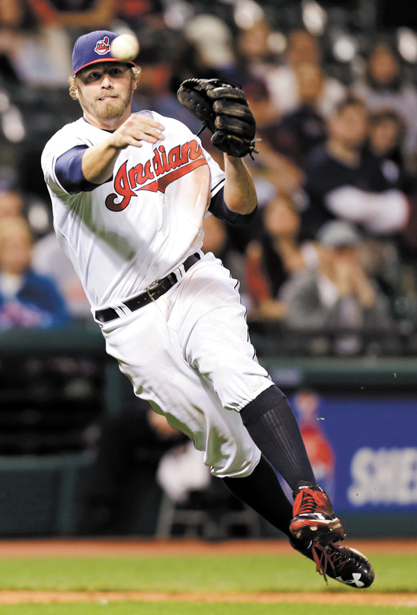Cleveland Indians third baseman Mark Reynolds throws out the Oakland Athletics’ Luke Montz in the ninth inning of a game Monday in Cleveland.