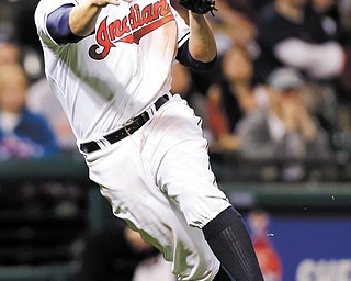 Cleveland Indians third baseman Mark Reynolds throws out the Oakland Athletics’ Luke Montz in the ninth inning of a game Monday in Cleveland.
