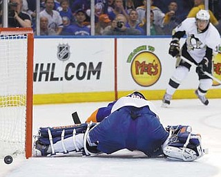 Pittsburgh Penguins left wing James Neal (18) watches as his shot goes past New York Islanders goalie Evgeni Nabokov (20) in the first period of Game 4 of their series Tuesday night at Nassau Coliseum.