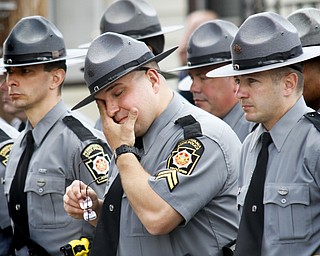 MADELYN P. HASTINGS | THE VINDICATOR
A Pennsylvania State Police Officer wipes away tears while standing with hundreds of police officers outside of St. Vitus church during a funeral service for Shenango Township Police Officer William “Jerry” McCarthy who was killed by Kylee Barletto in a car chase on May 2, 2013.