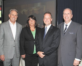 Greg Greenwood, owner of Greenwood Chevrolet in Austintown, left, received the Community Partner Award on Wednesday at the annual meeting of The Community Corp., United Way’s parent, at The Lake Club in Poland. Also attending the meeting were, from left, Becky Wall, 2013 campaign chairwoman; Theodore Schmidt, 2012 campaign chairman, and Robert Hannon, United Way president.