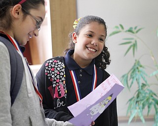 MADELYN P. HASTINGS | THE VINDICATOR
(L-R) Fifth graders Kimberly Nieves and Jailenette Morales read a Mother's Day card to residents at Danridge Nursing Home. The kids involved with the after school program at Martin Luther King Elementary presented the ladies of Danride Mother's Day cards, songs and poems.
