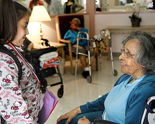 MADELYN P. HASTINGS | THE VINDICATOR
(L-R) Third grader in the afte rschool program at Martin Luther King Elementary, Amaryllis Rivera, gives a Mother's Day card to Metlean Singleton, resident at Danridge Nursing Home in Youngstown. The kids involved with the after school program presented the ladies of Danridge Mother's Day cards, songs and poems.