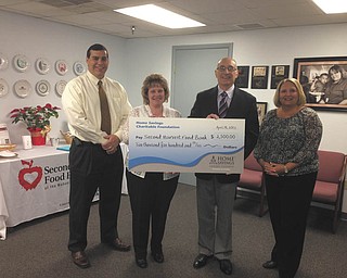 SPECIAL TO THE VINDICATOR
Home Savings Charitable Foundation has donated $2,500 to Second Harvest Food Bank of the Mahoning Valley to support two mobile pantry programs in rural Trumbull County. From left are Nicholas Kreatsoulas, D.O., board member of Second Harvest; Kim Gennaro, Home Savings Liberty; Michael Iberis, executive director of Second Harvest; and Colleen Miller, Home Savings McDonald. Second Harvest distributes food to hunger-relief organizations in Columbiana, Mahoning and Trumbull counties and provides education and advocacy. Its mobile pantry program is designed to get truckloads of food to those who live in underserved areas of the counties, or to those who do not have access to one of its 153 member agencies. For information about Second Harvest call 330-792-5522 or visit http://www.mahoningvalleysecondharvest.org.