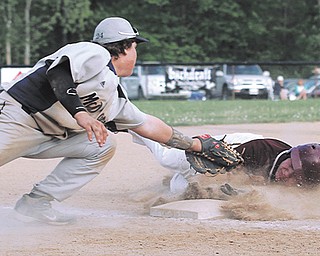 South Range baserunner Turner Curry avoids the tag by McDonald third baseman Mike Soots during the sixth inning of their baseball game Thursday at McDonald High School. The Raiders battered the Blue Devils 26-10.