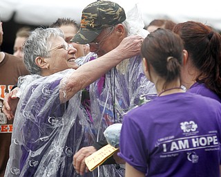 MADELYN P. HASTINGS | THE VINDICATOR
(L-R) Gloria and Edward Sersich from Warren finish the first lap of the Relay for Life. Edward is suffering from stage 4 bladder and lymphoma cancer and completed the entire first lap of the relay without the use of his wheelchair. The Warren Relay for Life, the largest in the state in terms of money raised, was held on Courthouse Square in downtown Warren on May 10, 2013.