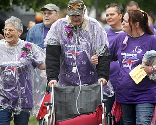MADELYN P. HASTINGS | THE VINDICATOR
(L-R) Gloria and Edward Sersich walk with their daughter Esther Pelayo, all from Warren in the Relay for Life. Edward is suffering from stage 4 bladder and lymphoma cancer and completed the entire first lap of the relay without the use of his wheelchair. The Warren Relay for Life, the largest in the state in terms of money raised, was held on Courthouse Square in downtown Warren on May 10, 2013.
