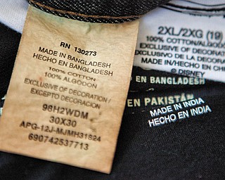 This illustration shows labels of garments made in Bangladesh, India, China and Pakistan that were bought at a Walmart store in Atlanta. Global clothing brands involved in Bangladesh’s troubled garment industry responded in starkly different ways to the building collapse that killed at least 1,100 people. Some quickly acknowledged their links to the tragedy and promised compensation. Others denied they authorized work at factories in the building even when their labels were found in the rubble.