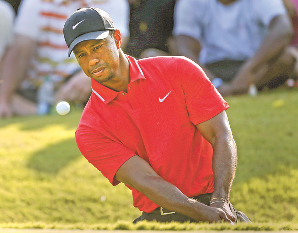 Tiger Woods hits onto the 15th green during the final round of The Players championship golf tournament
Sunday at TPC Sawgrass in Ponte Vedra Beach, Fla.