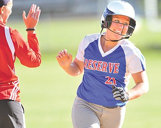 Western Reserve’s April Lude smiles upon receiving a high fi ve from her coach Laura Amero as she rounds third base after hitting a two-run himer in the fourth inning of Monday’s softball game against Columbiana in Columbiana. The Blue Devils extended their win streak in the ITCL Tier Two to 79 with a 10-5 victory over the Clippers.