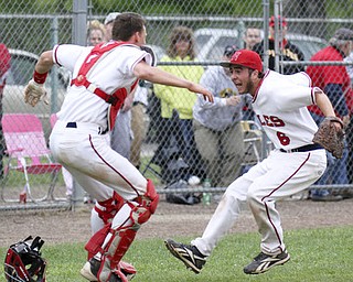 William d Lewis the Vindicator Niles catcher Ryan Ifft(4) and pitch Tyler Wiery(6) celebrate after defeating Canfield 1-0 during a Tuesday game at Niles.