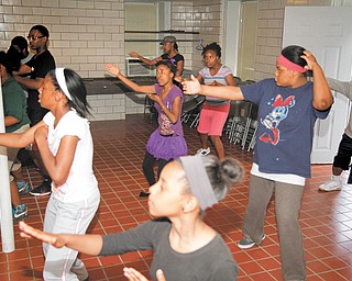 Members of Expressions for Life, a program of Warriors Inc., rehearse for the Warriors Inc. parade at 10 a.m. Saturday starting at Midlothian and Market streets in Youngstown. The faith-based organization offers an array of programs for youths and adults.